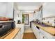 Bright kitchen with white cabinetry, wood countertops, and natural light at 110 E Church St, Creedmoor, NC 27522