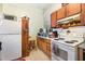 Classic kitchen with white appliances, tile floors, and wood accents at 110 E Church St, Creedmoor, NC 27522
