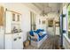 Cozy porch offers ample seating with wicker furniture and a cabinet at 110 E Church St, Creedmoor, NC 27522