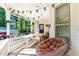 View of the front porch decorated with cafe string lights and a comfortable lounge chair at 110 E Church St, Creedmoor, NC 27522