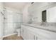 Bathroom features double sink vanity with granite countertop, tile floors, and a glass-enclosed shower at 110 Hays St, Oxford, NC 27565