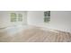 Bright bedroom featuring wood-look flooring, neutral walls, and large windows offering ample natural light at 110 Hays St, Oxford, NC 27565
