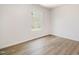 This bedroom offers a bright window, neutral walls, and attractive wood-look floors at 110 Hays St, Oxford, NC 27565