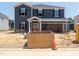 New construction two-story home featuring a welcoming front porch and a spacious two car garage at 1105 Landen Creek Ln, Zebulon, NC 27597