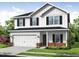 Charming two-story home featuring a two-car garage, brick accents, and classic board and batten siding at 112 Hays St, Oxford, NC 27565