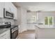 Well-equipped kitchen featuring granite counters, stainless steel appliances, and ample white cabinetry at 112 Hays St, Oxford, NC 27565