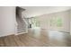 Open concept living room and kitchen offer an inviting space with wood-look floors and natural light at 112 Hays St, Oxford, NC 27565