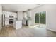 Modern kitchen featuring white cabinets, granite countertops, and stainless steel appliances at 114 Hays St, Oxford, NC 27565