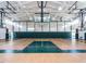 Indoor basketball court featuring a pristine hardwood floor, professional hoops, and ample space for recreational play at 1206 Chalk Maple Dr, Cary, NC 27519