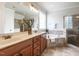 Bathroom with double sinks, bathtub, and glass-enclosed shower at 1206 Chalk Maple Dr, Cary, NC 27519