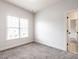Bright bedroom with plush carpeting and a large window for natural light at 1206 Chalk Maple Dr, Cary, NC 27519