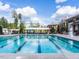 Long shot of Amberly's community pool and clubhouse featuring lawn chairs, lifeguard stand, and mature trees at 1206 Chalk Maple Dr, Cary, NC 27519