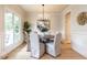 Elegant dining room with hardwood floors, wainscoting, and a stylish chandelier at 1206 Chalk Maple Dr, Cary, NC 27519