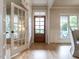 Light-filled entryway showcasing hardwood floors, a charming wood door and a glass paneled door at 1206 Chalk Maple Dr, Cary, NC 27519