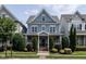 Charming blue two-story home featuring a landscaped yard and inviting front porch at 1206 Chalk Maple Dr, Cary, NC 27519