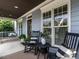 Inviting front porch featuring rocking chairs, a porch swing and stylish decor at 1206 Chalk Maple Dr, Cary, NC 27519
