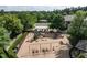 Community playground featuring swings, slides, and play structures surrounded by lush greenery and landscaping at 1206 Chalk Maple Dr, Cary, NC 27519