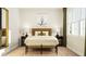 Bedroom featuring a bed with decorative pillows, bedside tables with lamps, a bench, and a natural fiber area rug at 1224 Coral Cay Bnd, Wake Forest, NC 27587
