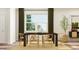 Dining room featuring a rustic table set, natural light from a bright window and modern decor at 1224 Coral Cay Bnd, Wake Forest, NC 27587