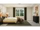 Serene primary bedroom with a large window, neutral colors, and modern furnishings for a relaxing retreat at 1224 Coral Cay Bnd, Wake Forest, NC 27587
