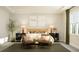 Spacious primary bedroom featuring bedside tables, a window for natural light, and stylish decor at 1224 Coral Cay Bnd, Wake Forest, NC 27587