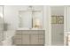 Bright bathroom featuring a large mirror, updated vanity and hardware, and glass enclosed tub/shower at 1232 Coral Cay Bnd, Wake Forest, NC 27587