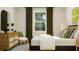 Modern bedroom with a large window, decorative rug, stylish dresser, and comfortable seating at 1232 Coral Cay Bnd, Wake Forest, NC 27587