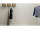 Minimalist closet with hanging clothes and storage baskets on the upper shelf at 1232 Coral Cay Bnd, Wake Forest, NC 27587