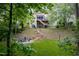 Lush backyard featuring a stone fire pit, steps, and swing set at 12424 Beauvoir St, Raleigh, NC 27614