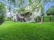 Spacious backyard with manicured lawn, black metal fence, and a walkout basement at 12424 Beauvoir St, Raleigh, NC 27614