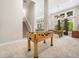 Finished basement with a foosball table, pool table, and large windows for natural light at 12424 Beauvoir St, Raleigh, NC 27614