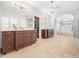 Bathroom with dual vanities, a soaking tub, and walk-in shower at 12424 Beauvoir St, Raleigh, NC 27614