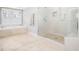 Well-lit bathroom with tub, walk-in shower, and neutral tile at 12424 Beauvoir St, Raleigh, NC 27614