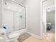 Bathroom featuring white subway tile shower over tub and view to adjacent bedroom at 12424 Beauvoir St, Raleigh, NC 27614
