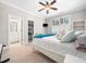 Bright bedroom with ensuite bathroom, walk-in closet and a white bed at 12424 Beauvoir St, Raleigh, NC 27614