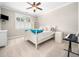 Cozy bedroom with a ceiling fan and natural light from shuttered windows at 12424 Beauvoir St, Raleigh, NC 27614