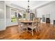 Elegant dining room featuring hardwood floors, a chandelier, and a large window at 12424 Beauvoir St, Raleigh, NC 27614