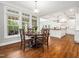 Elegant dining area featuring hardwood floors, natural lighting, and stylish decor at 12424 Beauvoir St, Raleigh, NC 27614