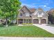 Stunning two-story home with a stone and siding exterior, well-manicured lawn, and a two-car garage at 12424 Beauvoir St, Raleigh, NC 27614