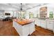 Beautiful kitchen with wood island, coffered ceilings, and seamless open floor plan at 12424 Beauvoir St, Raleigh, NC 27614