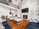 Cozy living room with hardwood floors, a fireplace, built-in shelving, and staircase at 12424 Beauvoir St, Raleigh, NC 27614