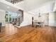 Spacious living area with hardwood floors, a staircase, and a dining area with a chandelier at 12424 Beauvoir St, Raleigh, NC 27614