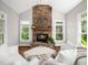 Comfortable living room with stone fireplace, natural light, and stylish furniture at 12424 Beauvoir St, Raleigh, NC 27614