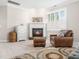 Comfortable sitting area with fireplace, plush chair, and ottoman at 12424 Beauvoir St, Raleigh, NC 27614