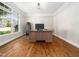 Office featuring hardwood floors, a window, and a large wooden desk at 12424 Beauvoir St, Raleigh, NC 27614