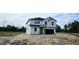 New two-story home with Tyvek wrap in a serene setting, surrounded by lush trees at 127 Caspian Ct, Lillington, NC 27546