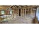 Upstairs loft featuring exposed framing, windows, and open layout at 127 Caspian Ct, Lillington, NC 27546