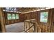 Upstairs loft space under construction, featuring stud walls, windows, and staircase at 127 Caspian Ct, Lillington, NC 27546