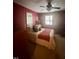 Bedroom showcasing a comfortable bed, classic ceiling fan, and natural light from the windows at 130 Beechwood Dr, Carrboro, NC 27510