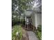 Home exterior featuring wood siding, a welcoming entrance, and complemented by mature trees and landscaping at 130 Beechwood Dr, Carrboro, NC 27510